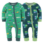 Two green baby rompers with vehicle patterns on a white background